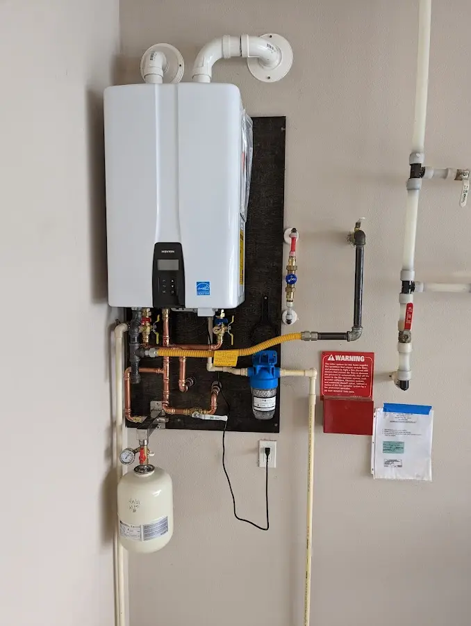 Professional plumber installing copper piping in a Draper home